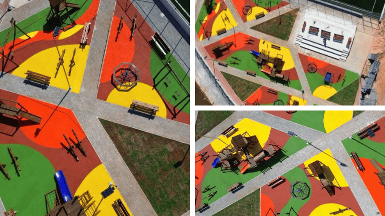 Vista aérea de playground ao ar livre com piso emborrachado colorido, brinquedos infantis e áreas de circulação.